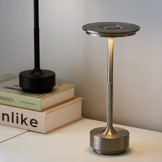 Modern table lamp with a metallic base on a light surface.