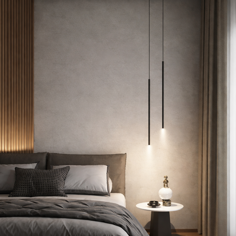 A modern bedroom interior with a bed dressed in gray bedding and two slim black pendant lights