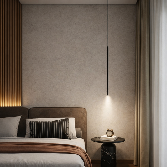 A modern bedroom interior featuring a slim black pendant light