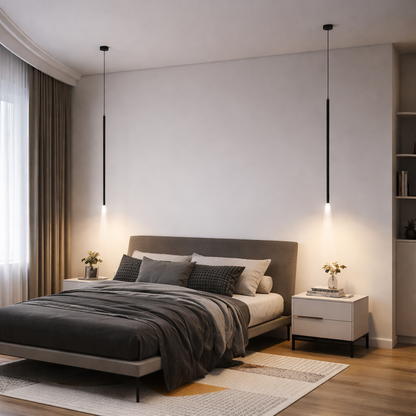 A modern bedroom interior featuring two slim black pendant lights hanging above the bed