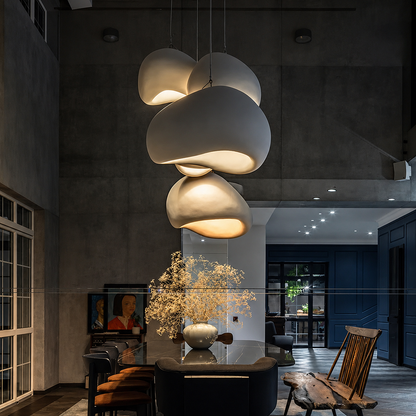 A modern multi-light pendant chandelier with organic, cloud-like white shades