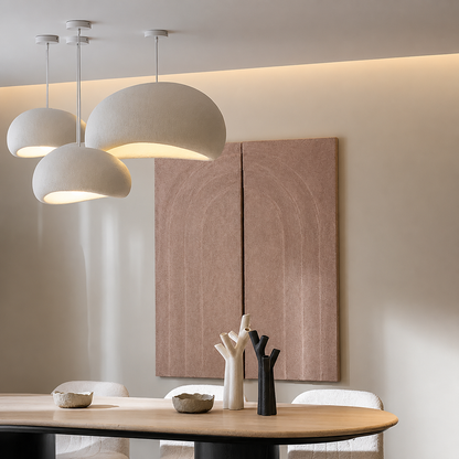 Three modern dome-shaped pendant lights in a warm off-white shade 