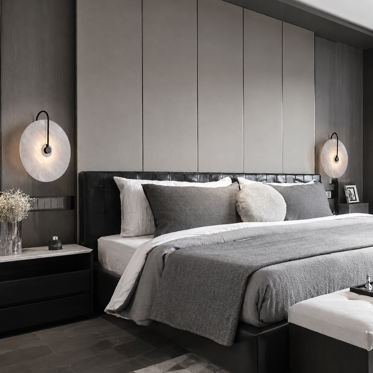 A modern bedroom featuring  two black wall sconces on either side of the bed