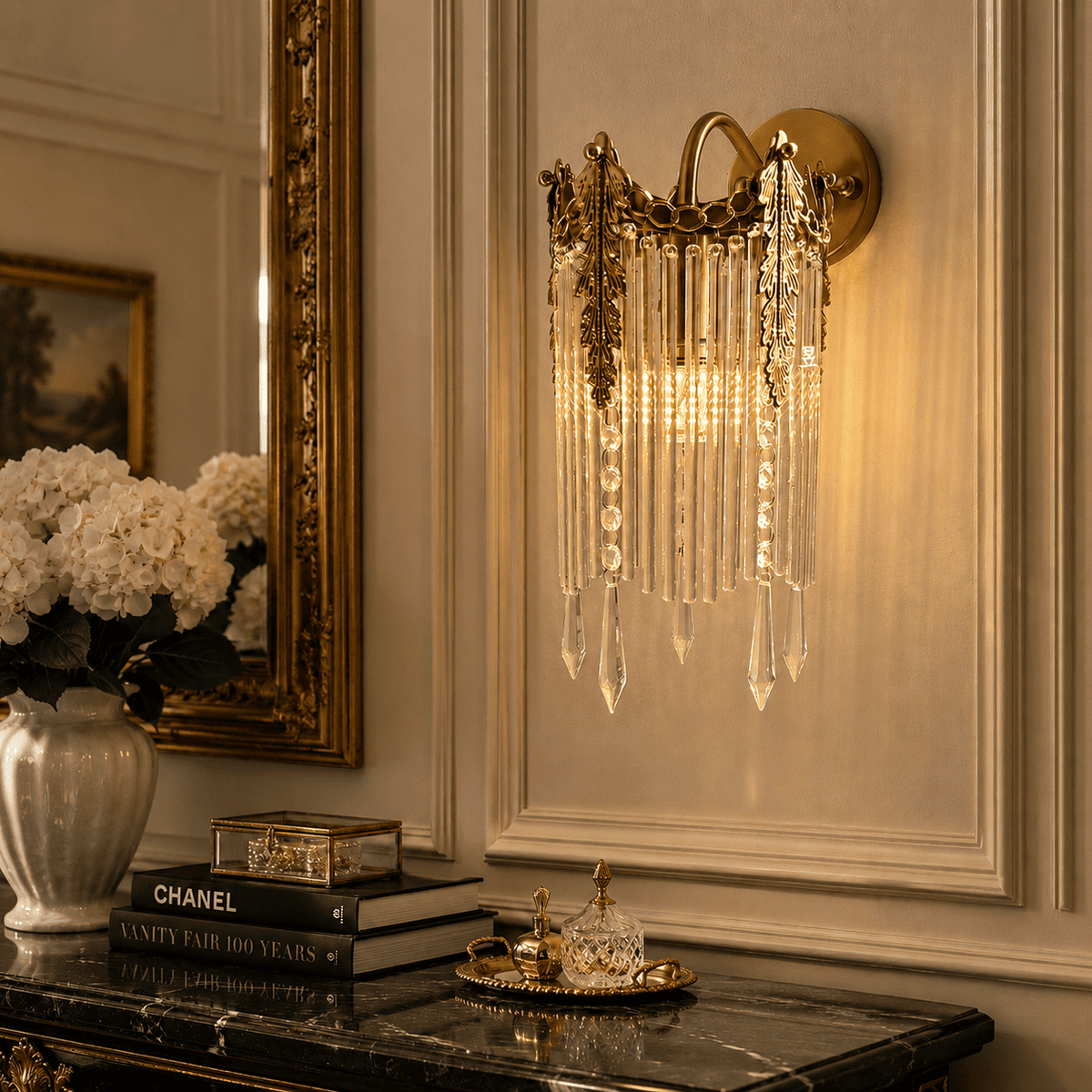 Wall sconce with hanging clear crystal prisms, mounted on a beige paneled wall