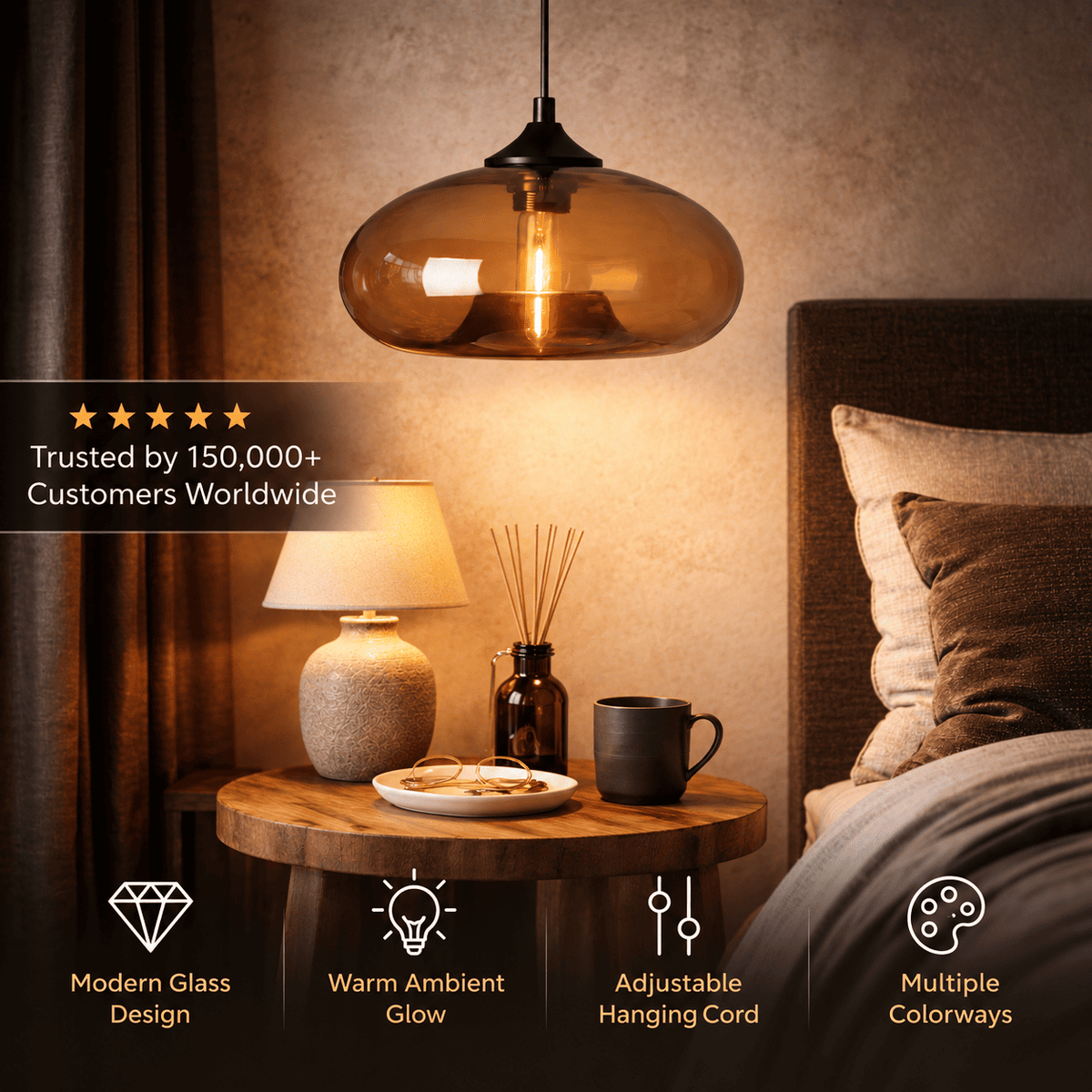 A modern pendant light with a warm amber-tinted glass dome and black metal hardware