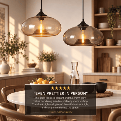 Two amber glass pendant lights hanging over a dining table