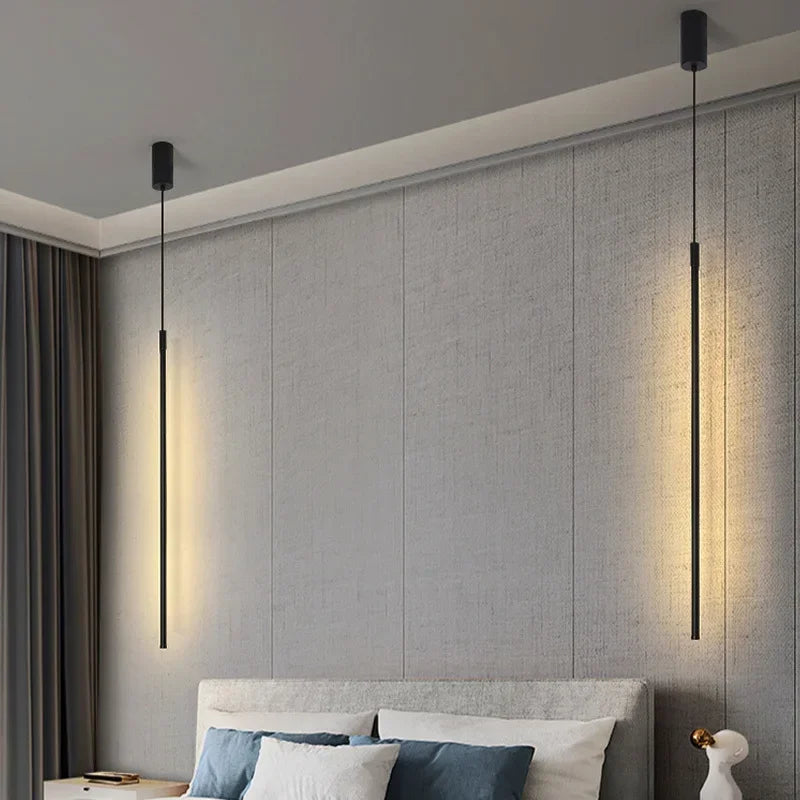 Modern bedroom with gray textured wall, bed, and pendant lights