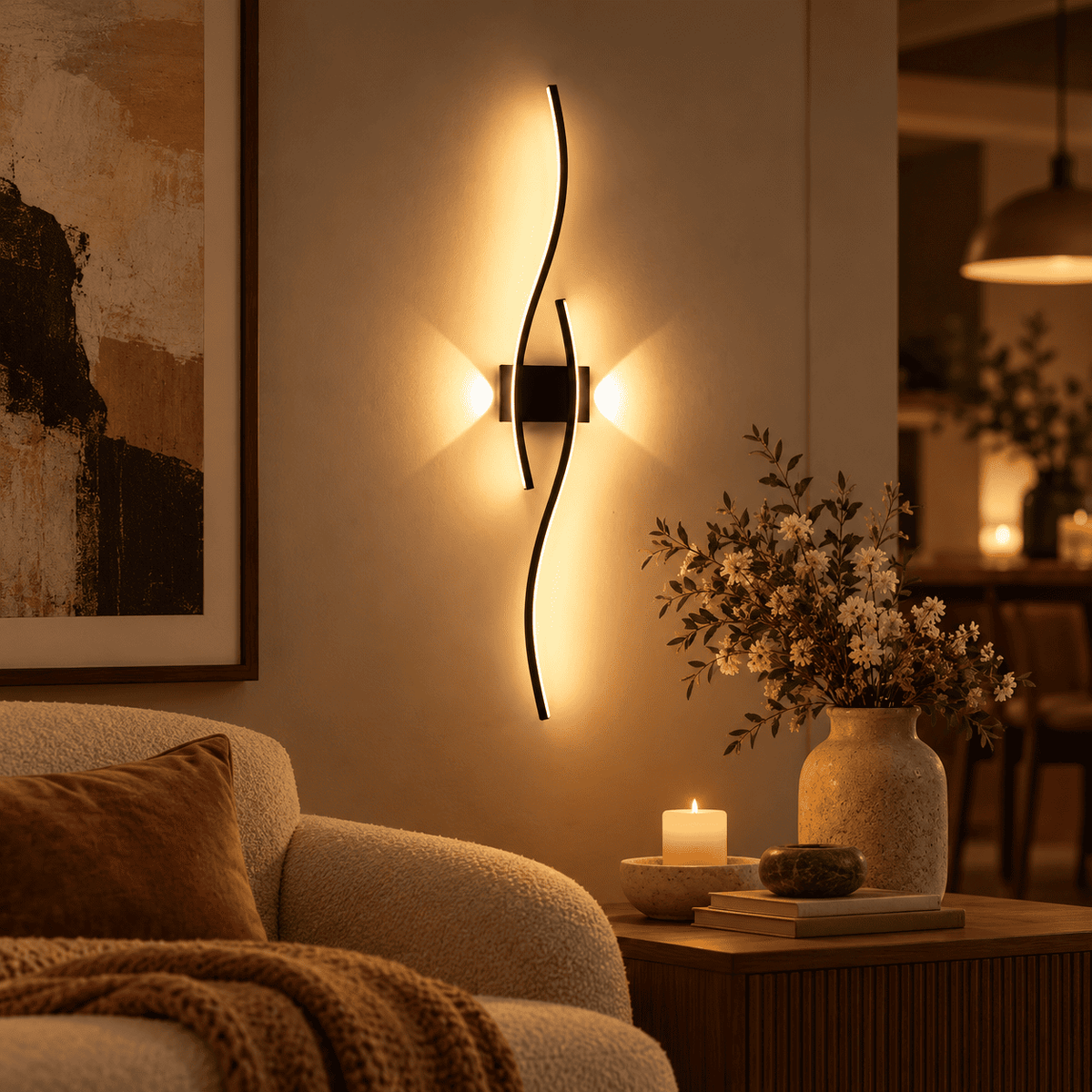 A modern wall-mounted light fixture with two curved black metal arms glowing warm light