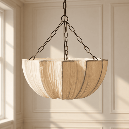 A hanging pendant light with a large, pleated drum shade in a beige tone