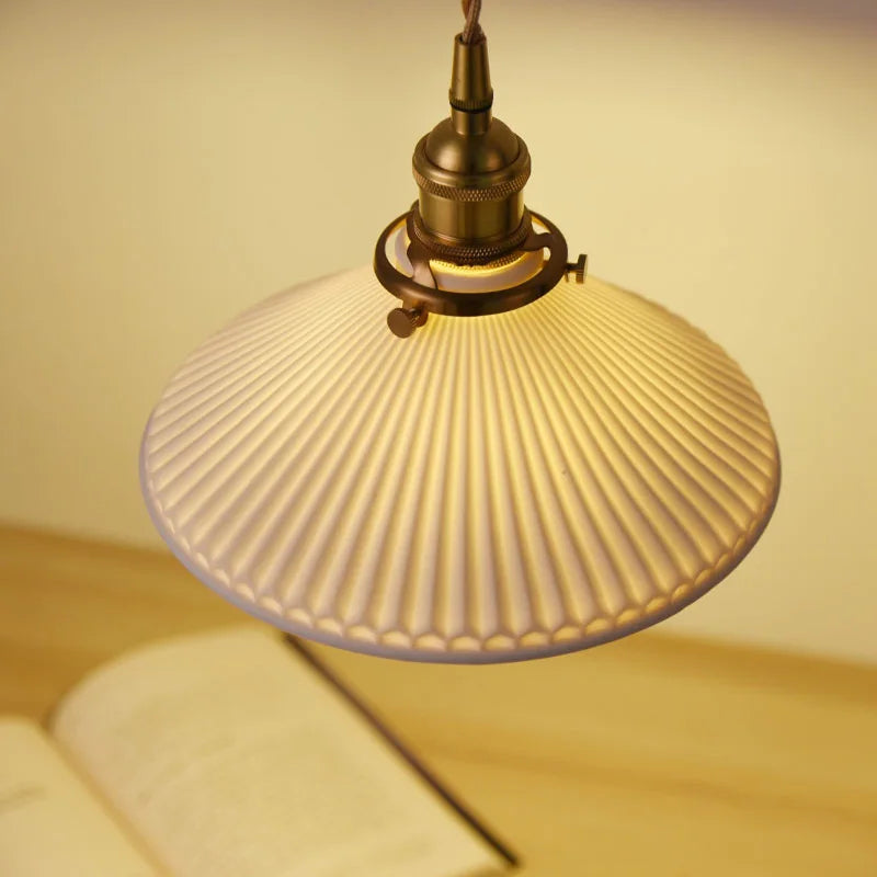 Vintage-style pendant light with ribbed glass shade on a neutral background