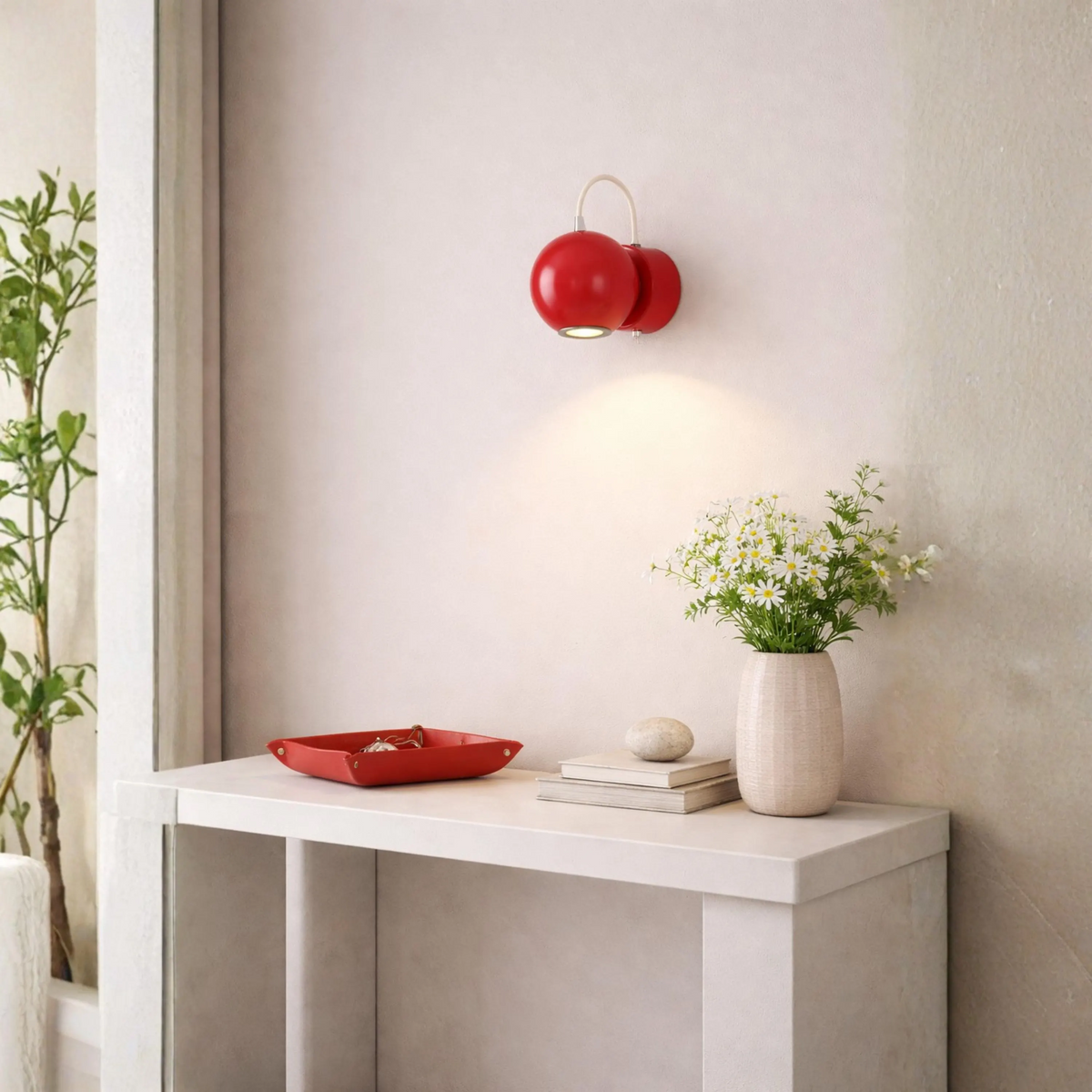 A modern red spherical wall sconce